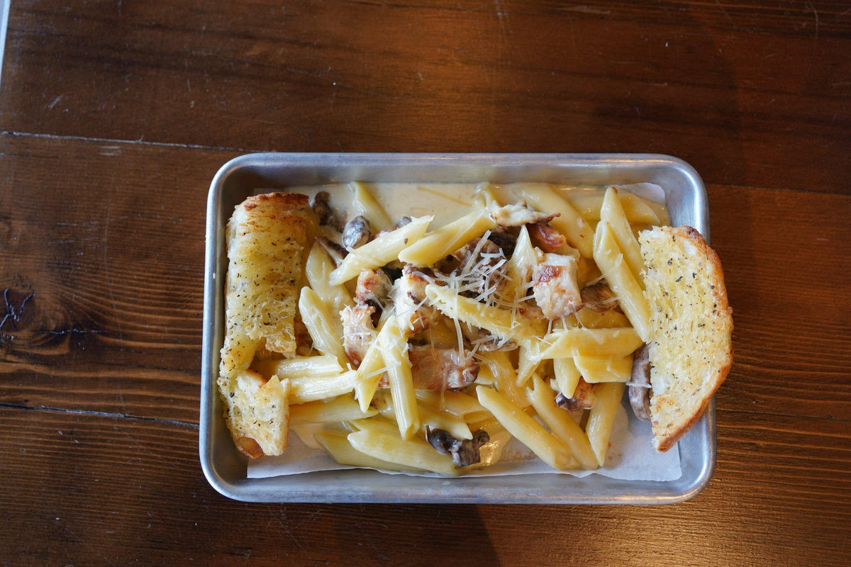 Chicken Alfredo penne with mushrooms and garlic bread