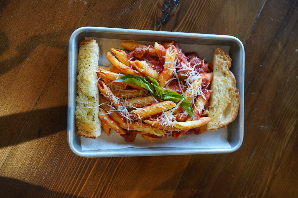 Penne in marinara with fresh basil, Parmesan, and garlic bread
