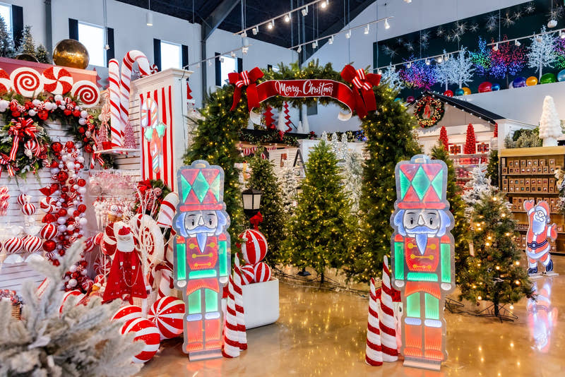 Life-size nutcrackers under a Merry Christmas arch in the Madisonville showroom
