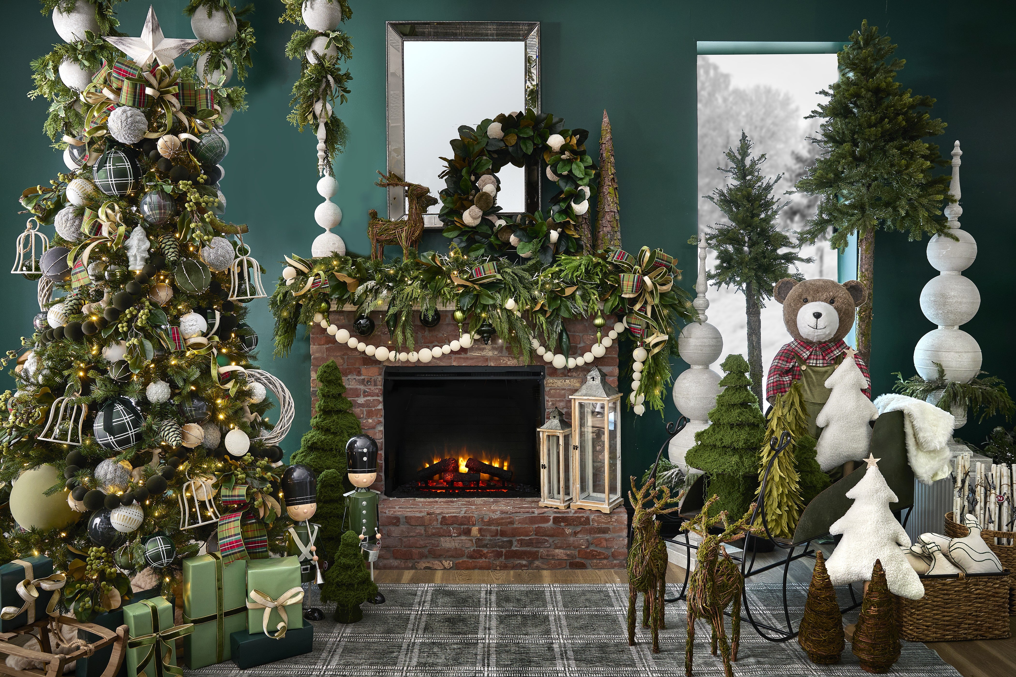 Decorated Christmas tree beside a fireplace with festive holiday decor